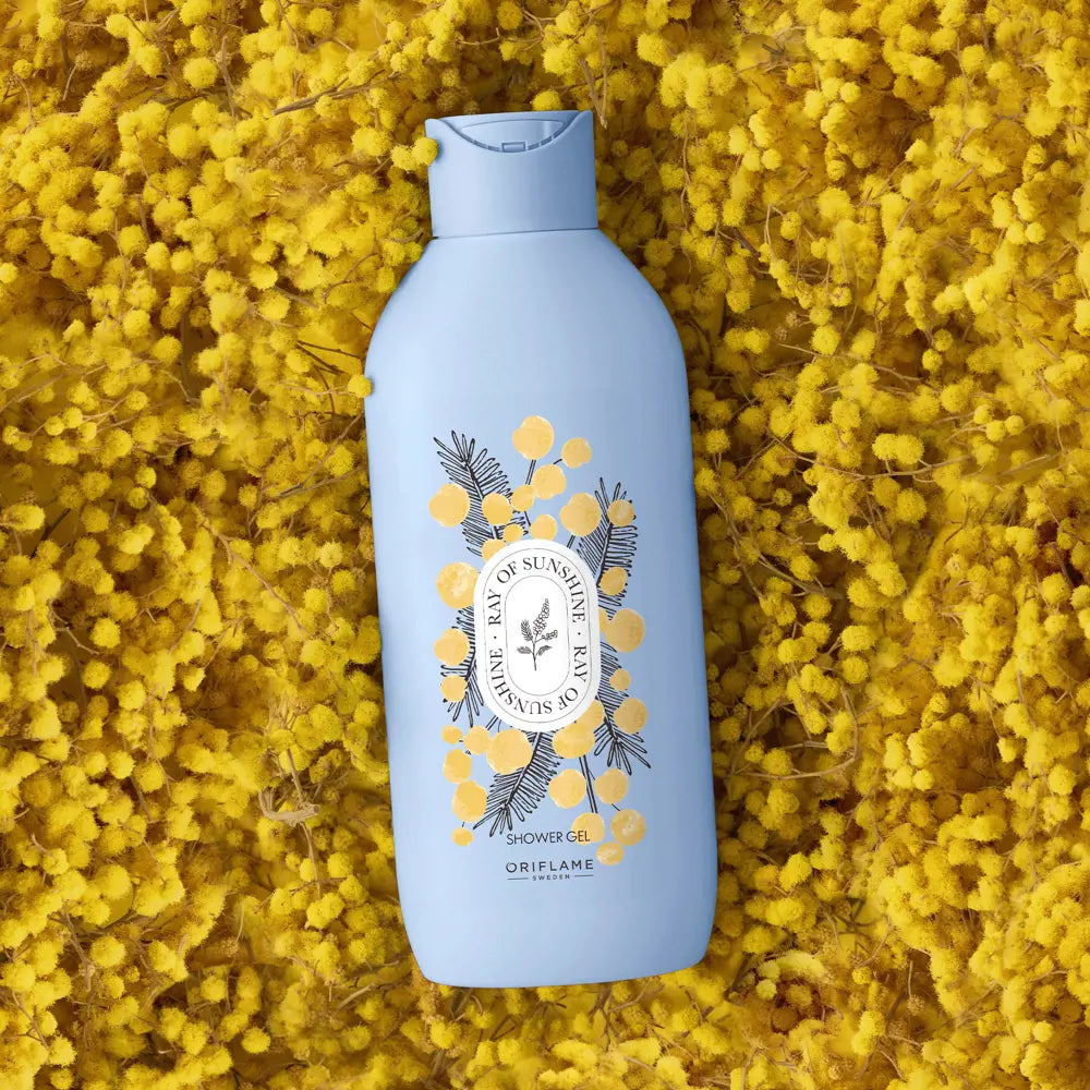 Blue bottle of shower gel with a floral design on a yellow floral background