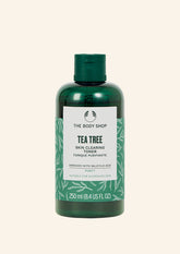 Green bottle of The Body Shop Tea Tree Skin Clearing Toner on a white background
