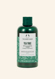 Green bottle of The Body Shop Tea Tree Skin Clearing Toner on a white background