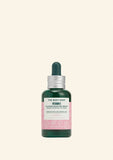 The Body Shop Vitamin E serum bottle on a light green background