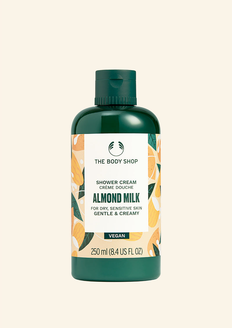 Bottle of The Body Shop Almond Milk shower cream on a white background