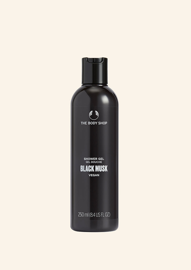 Black shower gel bottle with 'The Body Shop' branding on a beige background