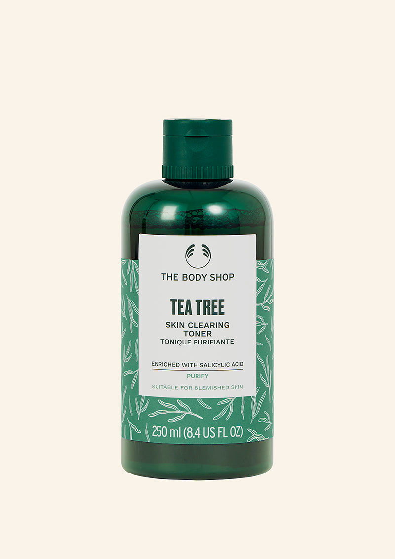Green bottle of The Body Shop Tea Tree Skin Clearing Toner on a white background