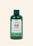 Green bottle of The Body Shop Tea Tree Skin Clearing Toner on a white background