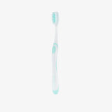 White toothbrush with green accents on a white background