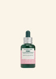 The Body Shop Vitamin E serum bottle on a light green background