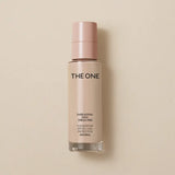 Foundation bottle labeled 'The One' on a beige background